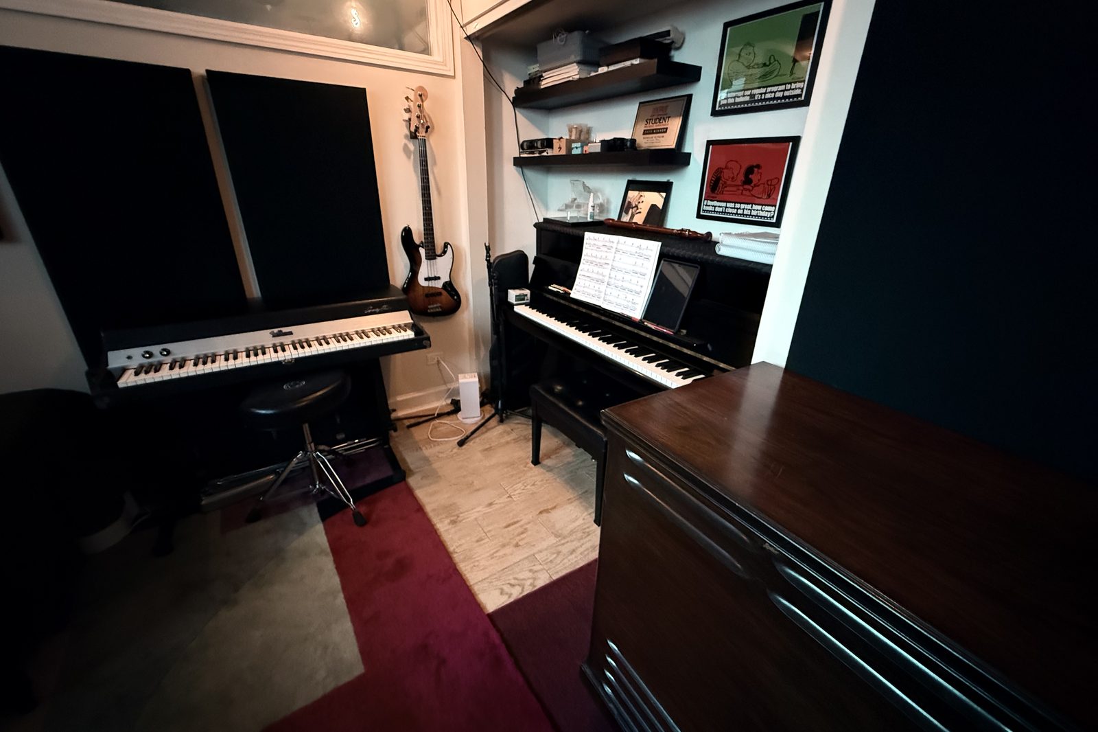 Music with Nick studio in Chicago's Ukrainian Village — upright piano, Fender Rhodes, framed posters, bass on the wall